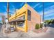 A corner building with a brick side and painted front, a sign on the corner reads 'Lola Coffee Open' at 231 W Portland St, Phoenix, AZ 85003