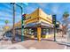 Bright yellow corner building with black trim, a sign on the corner reads 'Pizza Jungle' at 231 W Portland St, Phoenix, AZ 85003