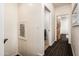 Hallway with neutral walls, decorative painting, and access to bathroom and other rooms at 231 W Portland St, Phoenix, AZ 85003