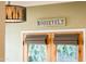 Close up of french doors with roman shade blinds and leafy green backyard view at 231 W Portland St, Phoenix, AZ 85003