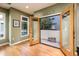 Bright living room featuring wood floors, large windows, and French doors to outdoor patio at 231 W Portland St, Phoenix, AZ 85003