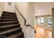 Carpeted staircase with decorative pattern, leading to well-lit hallway and living area at 231 W Portland St, Phoenix, AZ 85003