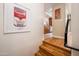 Stairway leading to an inviting kitchen with gorgeous wood floors and bright artwork at 231 W Portland St, Phoenix, AZ 85003