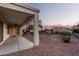 A covered patio enhances this low-maintenance backyard with desert landscaping at 23116 N Padaro Ct, Sun City West, AZ 85375