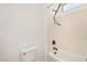 Bathroom featuring a toilet, a shower with black hardware, and a small window at 23116 N Padaro Ct, Sun City West, AZ 85375