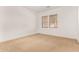 Carpeted bedroom with two windows providing natural light at 23116 N Padaro Ct, Sun City West, AZ 85375