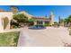 Inviting clubhouse entrance features mature trees, decorative fountain, and convenient guest parking at 23116 N Padaro Ct, Sun City West, AZ 85375