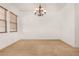 Expansive dining room with a chandelier and natural light at 23116 N Padaro Ct, Sun City West, AZ 85375