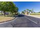 Tree lined street leading to the community entrance at 23116 N Padaro Ct, Sun City West, AZ 85375