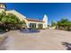 Exterior view of community building showcasing tile roof, fountain, and verdant landscaping at 23116 N Padaro Ct, Sun City West, AZ 85375