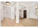 Bright open foyer with tile flooring, plush carpet and an entryway with natural lighting at 23116 N Padaro Ct, Sun City West, AZ 85375