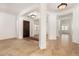 Bright entryway featuring tile and carpet floors, pillars and natural light at 23116 N Padaro Ct, Sun City West, AZ 85375