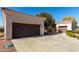 Driveway featuring a spacious 2-car garage on a sunny day at 23116 N Padaro Ct, Sun City West, AZ 85375