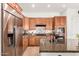 Close up of a bright kitchen showcasing stainless steel appliances, granite countertops, and backsplash at 23116 N Padaro Ct, Sun City West, AZ 85375