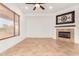 Living room featuring a fireplace and a window with blinds at 23116 N Padaro Ct, Sun City West, AZ 85375