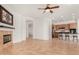 Open-concept living room with a fireplace and bar seating at 23116 N Padaro Ct, Sun City West, AZ 85375