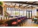 Beautifully appointed restaurant bar features warm wood tones, pendant lighting, and views to lush landscaping at 23116 N Padaro Ct, Sun City West, AZ 85375