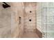 Walk-in shower with tile, glass block, and modern shower fixtures at 23116 N Padaro Ct, Sun City West, AZ 85375