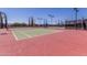 Well-maintained tennis courts with new surfaces, nets, and blue shaded benches at 23116 N Padaro Ct, Sun City West, AZ 85375