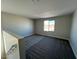 Cozy bonus room with plush carpet, a bright window, and a neutral color scheme at 23229 W Florence Ave, Buckeye, AZ 85326