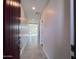 Inviting hallway with tile flooring, neutral walls, and recessed lighting leading to an open living space at 23229 W Florence Ave, Buckeye, AZ 85326