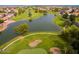 Overhead view of golf course featuring a pond, sand trap and lush green fairways in a residential community at 23731 S Angora Dr, Sun Lakes, AZ 85248