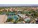 Aerial view of the tennis courts, pool, and surrounding residential area in a well-maintained community at 23731 S Angora Dr, Sun Lakes, AZ 85248