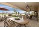 Covered patio with dining table and chairs overlooking lush golf course at 23731 S Angora Dr, Sun Lakes, AZ 85248