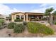 Landscaped backyard with covered patio, outdoor grill, and golf course views at 23731 S Angora Dr, Sun Lakes, AZ 85248