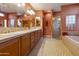 Well-lit bathroom offers a dual-sink vanity, soaking tub and separate shower; ceiling fan included at 23731 S Angora Dr, Sun Lakes, AZ 85248