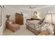 Spacious bedroom featuring floral bedding, a side chair, and a large wardrobe at 23731 S Angora Dr, Sun Lakes, AZ 85248