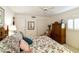 Comfortable bedroom with floral bedding, side table, and a large wardrobe at 23731 S Angora Dr, Sun Lakes, AZ 85248