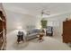 Bright living room featuring a ceiling fan, floral sofa, and decorative accents at 23731 S Angora Dr, Sun Lakes, AZ 85248