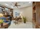 Cozy home office with wood bookshelves, carpeted floor, and a window for natural light, creating a professional workspace at 23731 S Angora Dr, Sun Lakes, AZ 85248