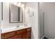 Bathroom featuring a vanity with a sink, an framed mirror, and a glass-enclosed shower at 2422 W Aloe Vera Dr, Phoenix, AZ 85085