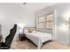 Simple bedroom with a twin-sized bed frame, bedside table, and a modern floor lamp at 2422 W Aloe Vera Dr, Phoenix, AZ 85085