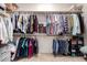 Walk-in closet with abundant storage options and wood shelving at 2422 W Aloe Vera Dr, Phoenix, AZ 85085