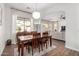 Dining room with hard wood floors, a large window, flowing into the living room at 2422 W Aloe Vera Dr, Phoenix, AZ 85085