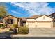 Charming single-story home featuring a three-car garage and desert landscaping at 2422 W Aloe Vera Dr, Phoenix, AZ 85085