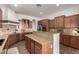 Gourmet kitchen features granite counters, stainless steel appliances, rich wood cabinetry and backsplash at 2422 W Aloe Vera Dr, Phoenix, AZ 85085