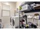 Functional laundry room featuring a pair of laundry machines and wire shelving at 2422 W Aloe Vera Dr, Phoenix, AZ 85085