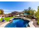 Inviting backyard oasis with sparkling pool, lush landscaping, and covered patio, perfect for outdoor entertaining at 2422 W Aloe Vera Dr, Phoenix, AZ 85085