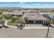 Expansive aerial shot of a desert community featuring tile roofs, a large 3-car driveway, and mountain views at 24670 N 171St Ln, Surprise, AZ 85387