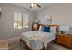 Bedroom with mid-century modern furniture, ceiling fan, and bright natural light at 24670 N 171St Ln, Surprise, AZ 85387