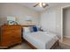 Comfortable bedroom featuring a wooden dresser, a ceiling fan, and neutral decor at 24670 N 171St Ln, Surprise, AZ 85387