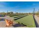 A close-up view of the community bocce ball court with chairs and manicured landscaping at 24670 N 171St Ln, Surprise, AZ 85387