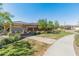 A community area featuring a shaded ramada, green grass, mature trees, and well-maintained sidewalks for residents at 24670 N 171St Ln, Surprise, AZ 85387