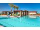 Community pool with shaded seating, cabanas, palm trees, and clear turquoise water at 24670 N 171St Ln, Surprise, AZ 85387