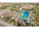 Overhead view of community pool area with lounge chairs, shaded cabanas, and well-maintained landscaping at 24670 N 171St Ln, Surprise, AZ 85387