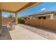 Covered patio with brick pavers, offering a charming outdoor living space, a small cafe table, and ample sunlight at 24670 N 171St Ln, Surprise, AZ 85387